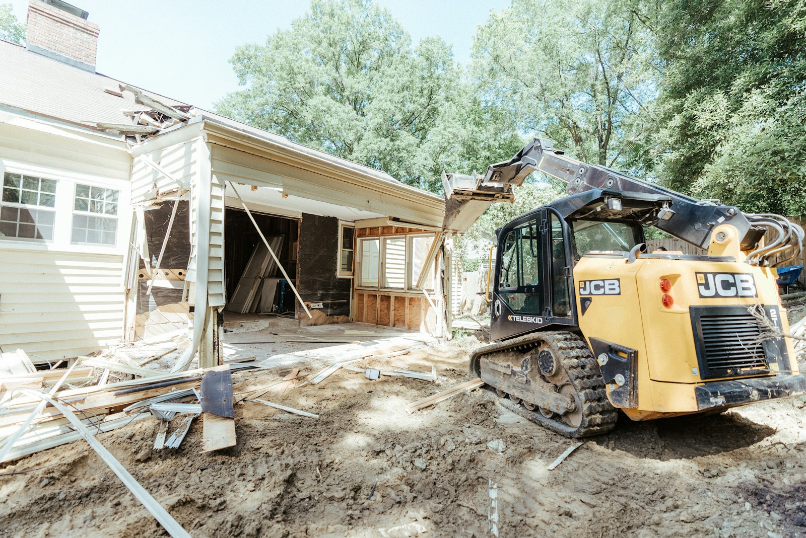 Photo by Samuel Cruz a bulldozer is parked in front of a house